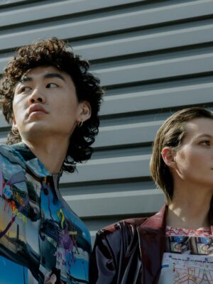 Stylish portrait of a diverse man and woman showcasing contemporary fashion against a sleek background.