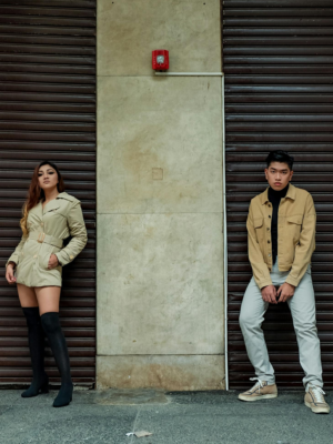 Stylish young adults posing in urban street fashion against a city backdrop.